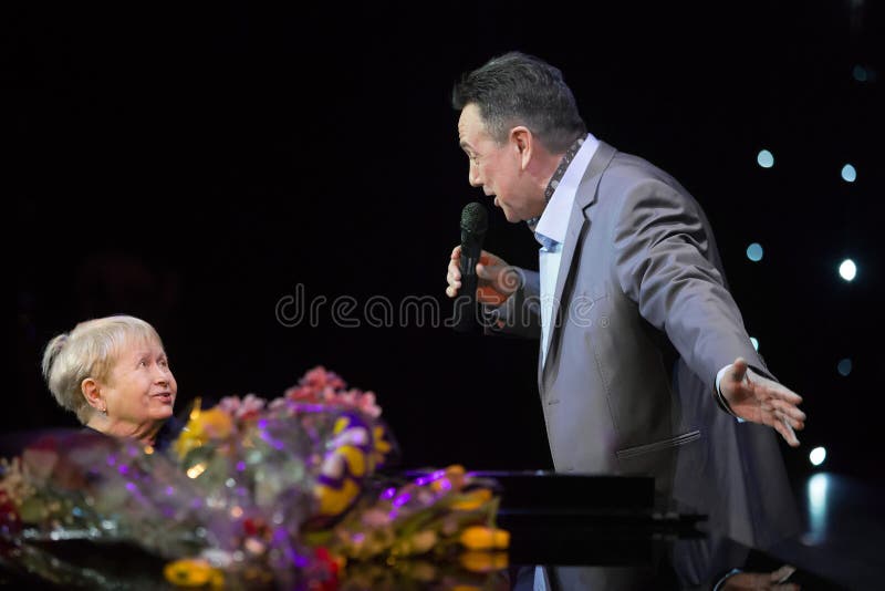 MOSCOW - FEB 26: Alexandra Pakhmutova on stage with Artist of Russia Renat Ibragimov present a new song in the Moscow International House of Music on February 26, 2013 in Moscow, Russia. Alexandra Pakhmutova outstanding Soviet and Russian composer, author of more than 400 songs. MOSCOW - FEB 26: Alexandra Pakhmutova on stage with Artist of Russia Renat Ibragimov present a new song in the Moscow International House of Music on February 26, 2013 in Moscow, Russia. Alexandra Pakhmutova outstanding Soviet and Russian composer, author of more than 400 songs.