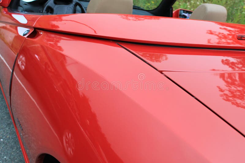 Rear left fender detail close up. 1990s red alfa romeo spider sports car at 2012 fiat freak out event in virginia. Rear left fender detail close up. 1990s red alfa romeo spider sports car at 2012 fiat freak out event in virginia.