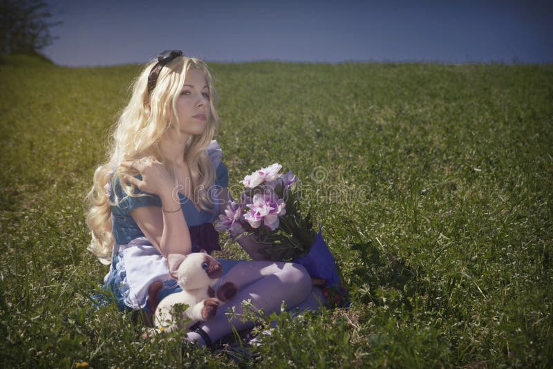 Portrait of a young woman dressed as Alice in Wonderland