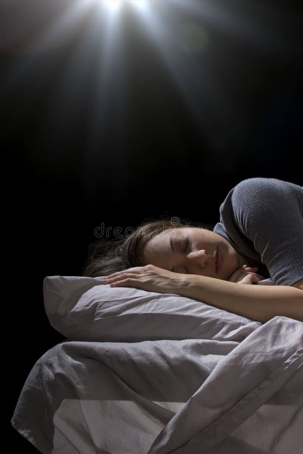 Creepy glowing orb hovering over a woman sleeping in bed. Creepy glowing orb hovering over a woman sleeping in bed