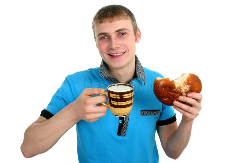 Men eat bread with powdered sugar and cup of milk. Men eat bread with powdered sugar and cup of milk.