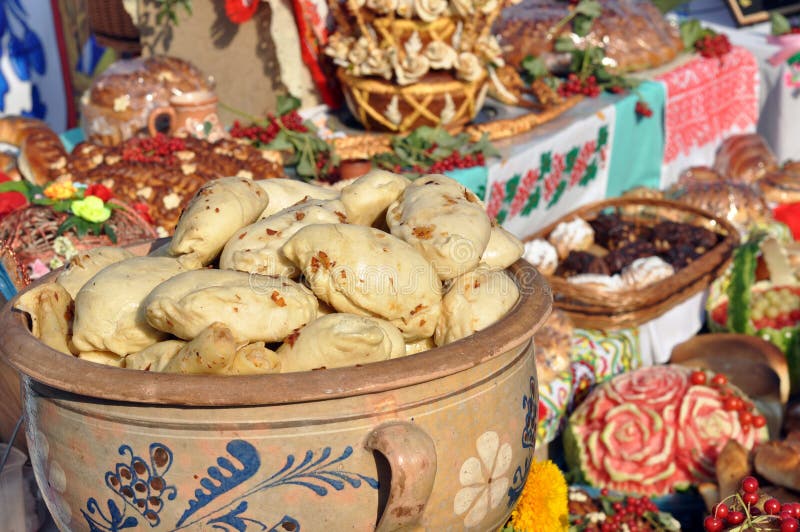 Traditional ukrainian food - dumplings (varenik) and various ukrainian food in festive decorating on background. Traditional ukrainian food - dumplings (varenik) and various ukrainian food in festive decorating on background