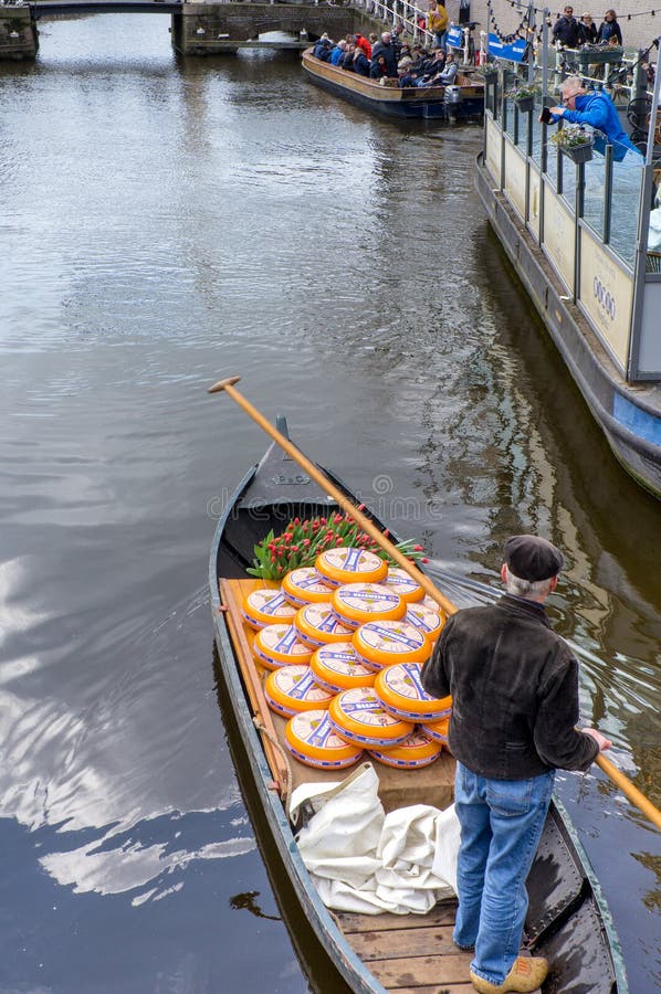 Alkmaar, the Netherlands - April 12, 2019: Cheese arrives to the cheese market by boat  in Alkmaar, Netherlands. Every friday