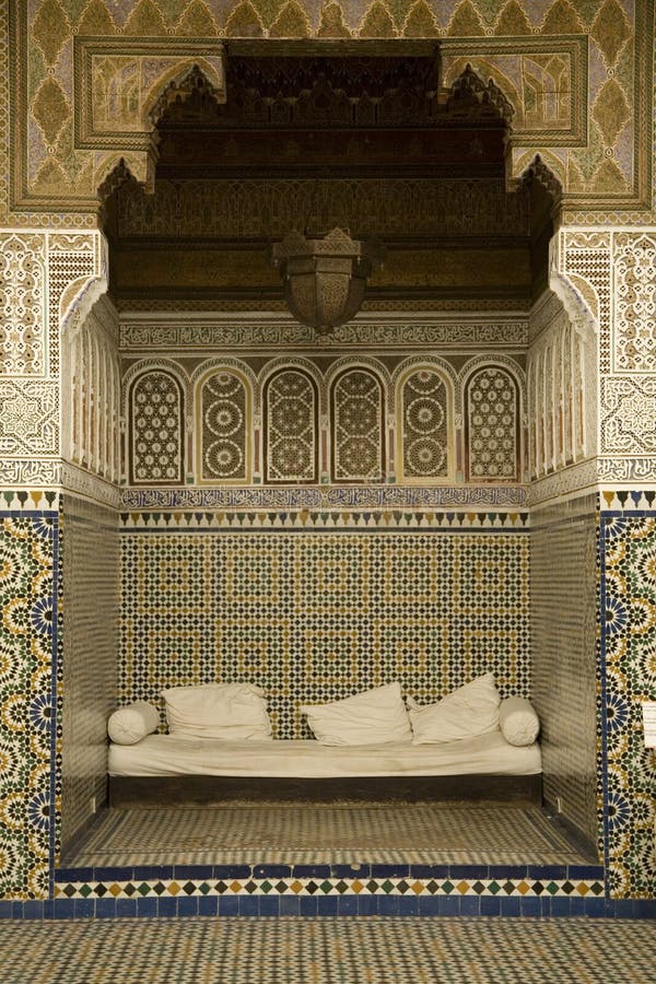 A view of a small alcove or or recessed seating with walls richly covered with traditional Arabian mosaics. Marrakesh, Morocco. A view of a small alcove or or recessed seating with walls richly covered with traditional Arabian mosaics. Marrakesh, Morocco.