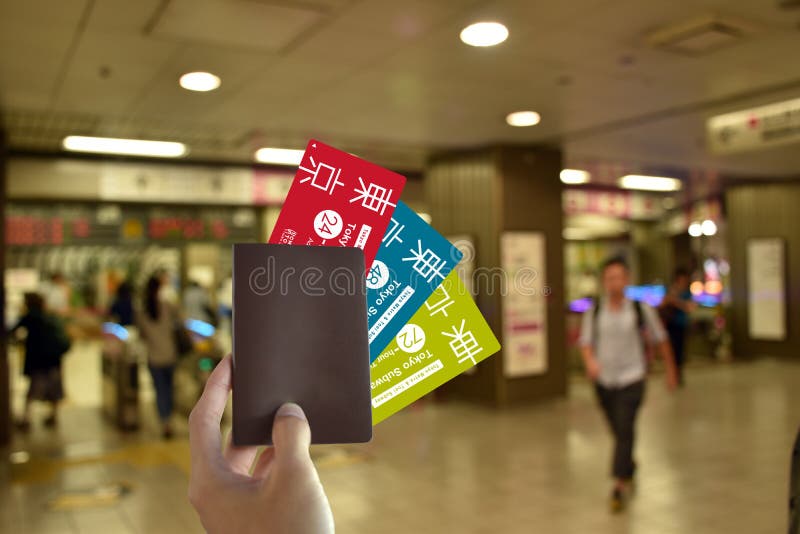 Hand with blank Passport and all subway card of japan to travel in Tokyo on blurred subway background royalty free stock images Hand with blank Passport and all subway card of japan to travel in Tokyo on blurred subway background royalty free stock images