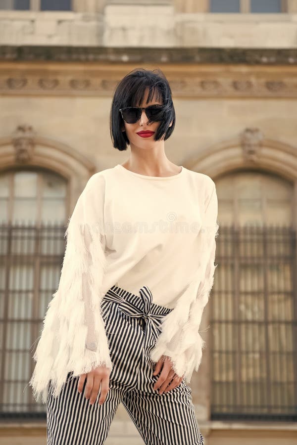 Alla moda e comodo Posa alla moda del modello della donna all'aperto L'acconciatura castana del peso della ragazza sembra alla mo fotografia stock Alla moda e comodo Posa alla moda del modello della donna all'aperto L'acconciatura castana del peso della ragazza sembra alla mo fotografia stock