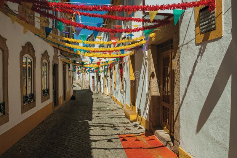 Alley with festive colorful decoration and old houses