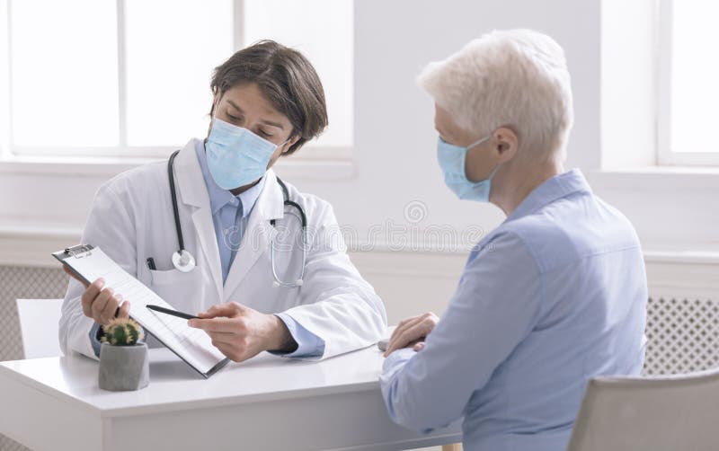 General practitioner showing analysis results to senior woman during preventive visit. General practitioner showing analysis results to senior woman during preventive visit