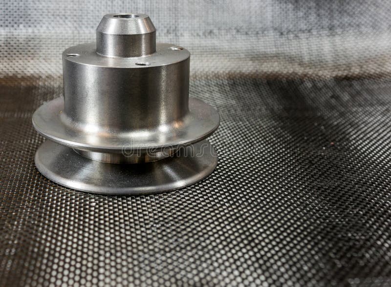 Alloggi la puleggia del modello A sulla fibra del carbonio della tela fotografia stock Alloggi la puleggia del modello A sulla fibra del carbonio della tela fotografia stock