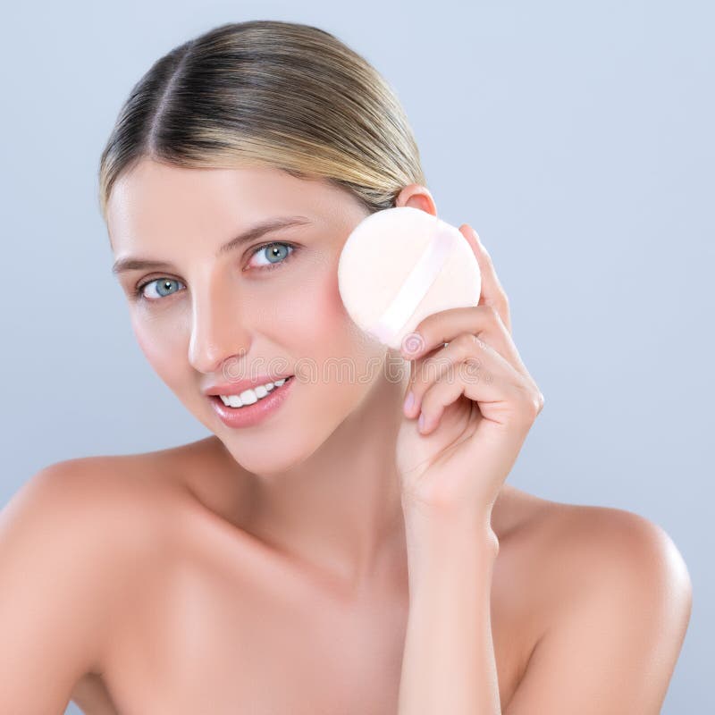 Alluring Beautiful Female Model Applying Powder Puff For Facial Makeup Concept Stock Image