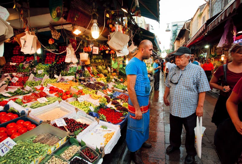 ISTANBUL: Serious customer and trader of food market talking on the busy street in Turkey. With population of 14.4 million, Istanbul is the 5th largest city in the world. ISTANBUL: Serious customer and trader of food market talking on the busy street in Turkey. With population of 14.4 million, Istanbul is the 5th largest city in the world