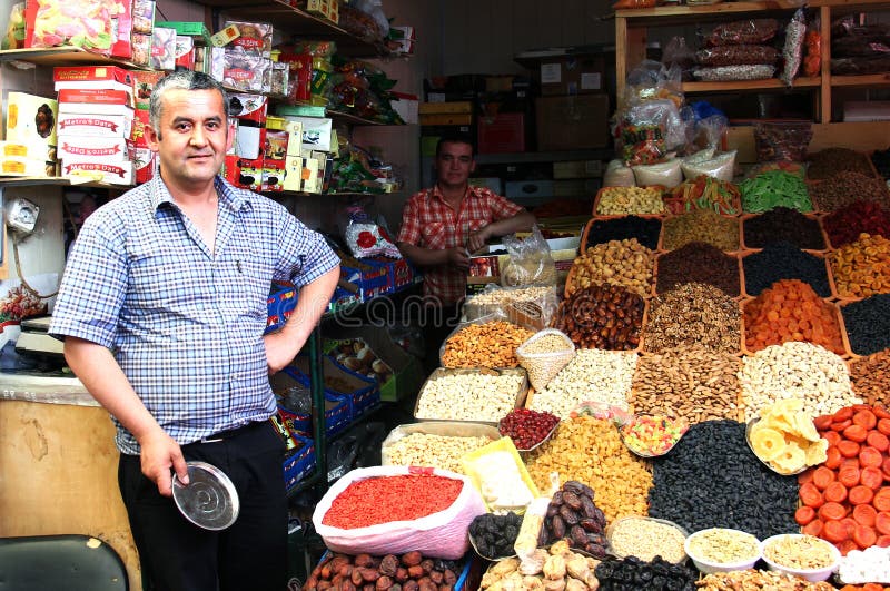 ALMATY, KAZAKHSTAN - MAY 30, 2014 - Green Bazaar. Vendor of dried fruits and nuts. ALMATY, KAZAKHSTAN - MAY 30, 2014 - Green Bazaar. Vendor of dried fruits and nuts.