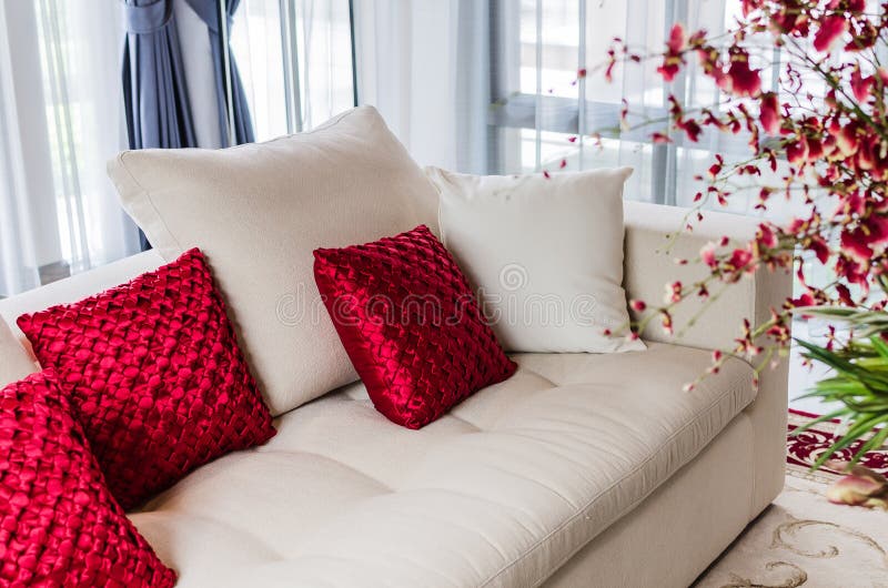 Red and white pillow on modern white sofa at home. Red and white pillow on modern white sofa at home