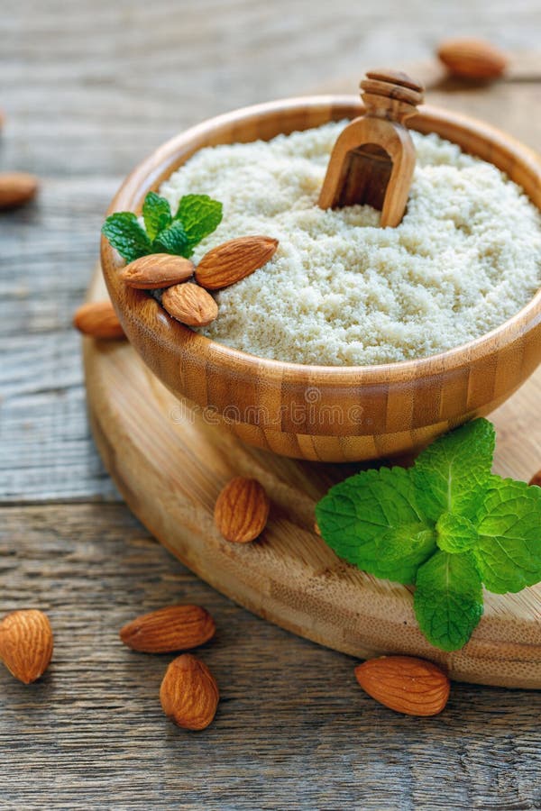 Almond Flour and Raw Almonds in a Wooden Bowl. Stock Photo Image of