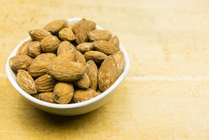 Almond seeds in a bowl. stock image. Image of food, organic 112025943