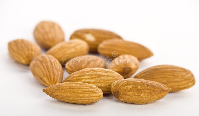 Almonds in pile on white background