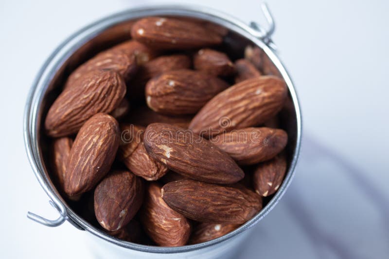 Almonds in Zinc Bucket, Viewpoint on a Marble Background Flat Lay Stock