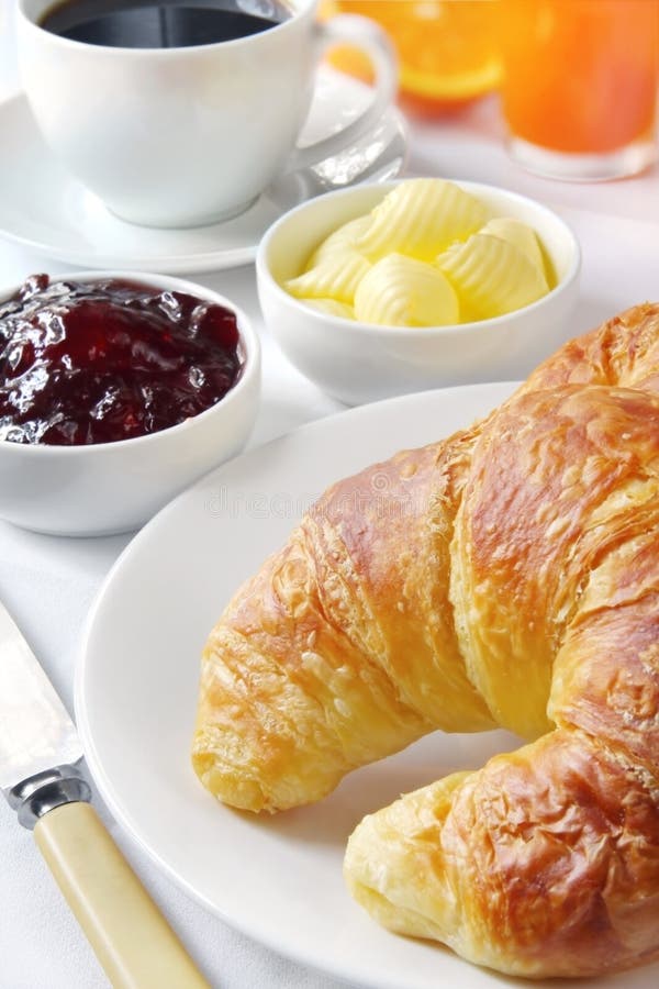 Continental breakfast with croissants, strawberry jam and butter curls, fresh orange juice and coffee. Continental breakfast with croissants, strawberry jam and butter curls, fresh orange juice and coffee.