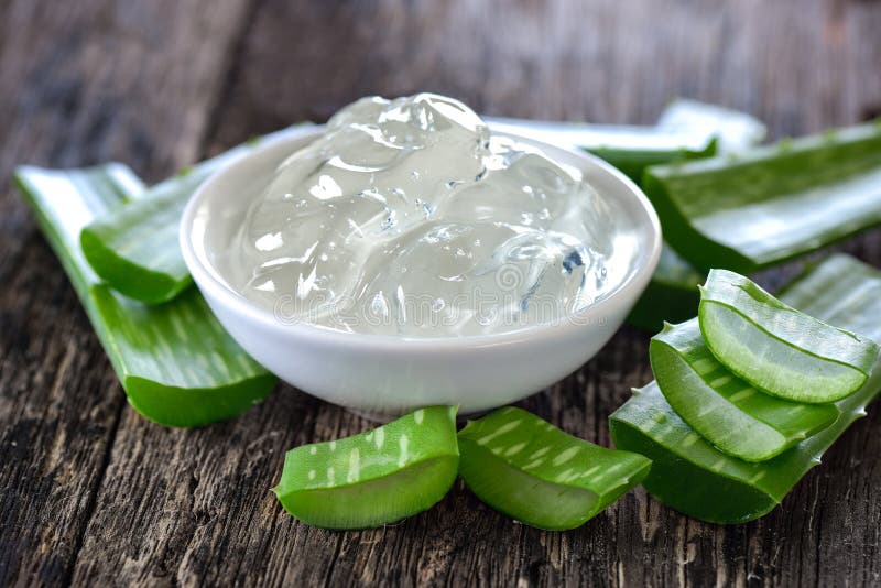 Aloe vera gel in bowl with on wooden table