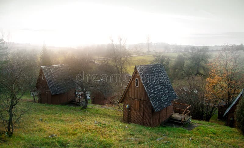 Wooden lodges in a foggy forest in Hungary. Wooden lodges in a foggy forest in Hungary.