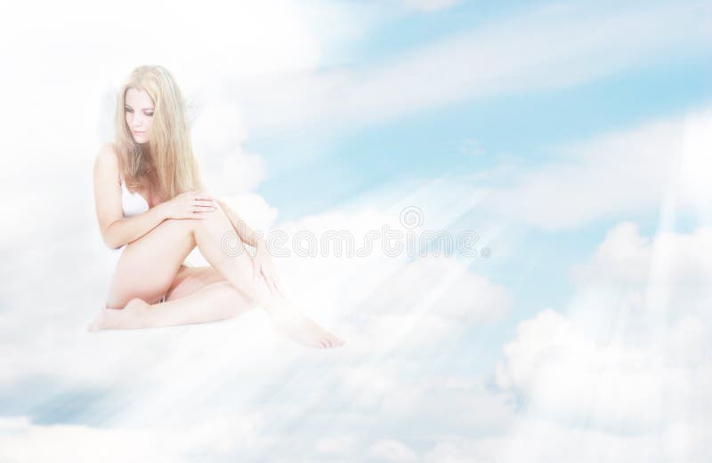 Alone angel girl in sun rays on clouds