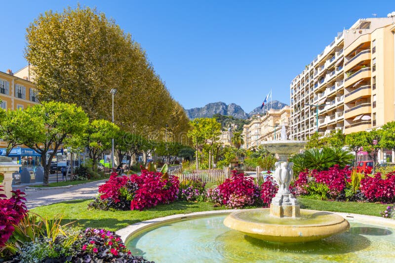 The Alpes Maritimes mountains rise behind the Jardins Bioves in the city center of the seaside village of Menton, France. stock photography The Alpes Maritimes mountains rise behind the Jardins Bioves in the city center of the seaside village of Menton, France. stock photography