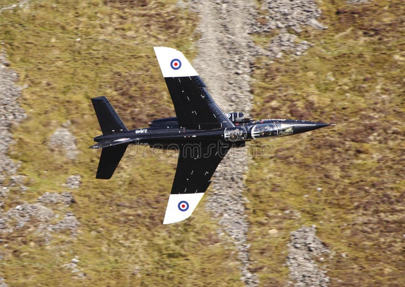 The Alpha jet is a lightweight attack and training jet. Here it passes meters from a mountain wall as it practices at low level flying. May 7th 2013, Mach Loop, Wales. The Alpha jet is a lightweight attack and training jet. Here it passes meters from a mountain wall as it practices at low level flying. May 7th 2013, Mach Loop, Wales.