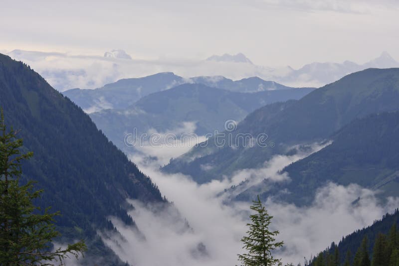 Mountains in the Hohe Tauern National Park seen from the Grossglockner High Alpine Road, the most famous alpine road leading into the heart of the National Park, to the highest mountain in Austria, the Grossglockner (3,798m) and its glacier, the Pasterze; passing through all of the vegetation zones from cornfields to the eternal ice. Mountains in the Hohe Tauern National Park seen from the Grossglockner High Alpine Road, the most famous alpine road leading into the heart of the National Park, to the highest mountain in Austria, the Grossglockner (3,798m) and its glacier, the Pasterze; passing through all of the vegetation zones from cornfields to the eternal ice.