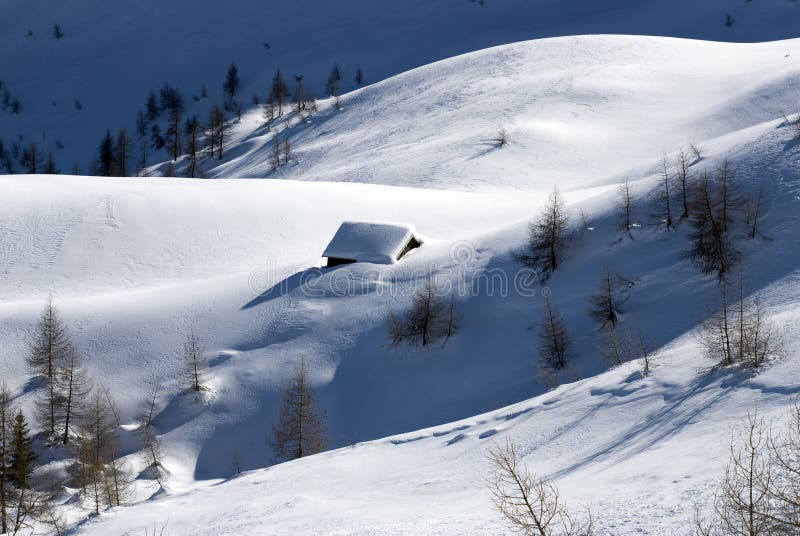 Alpine huts under snow