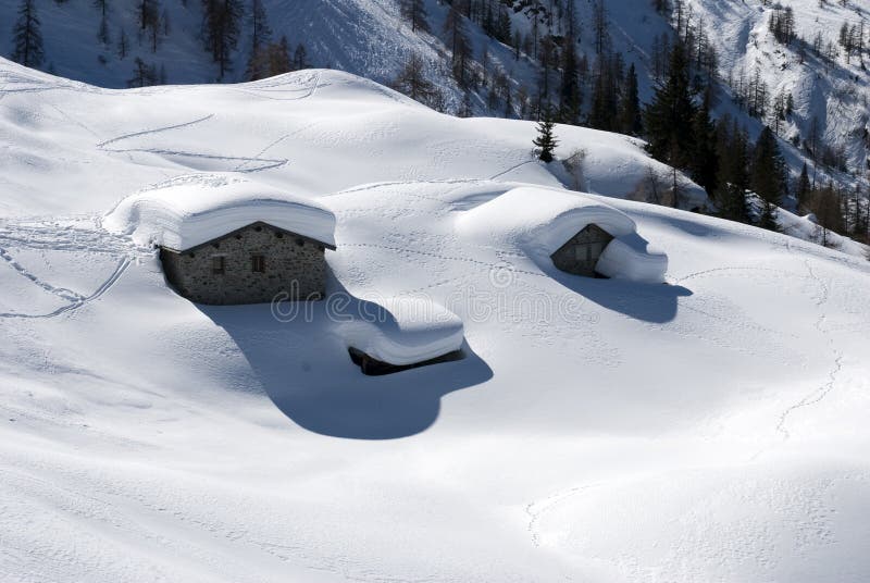 Alpine huts under snow