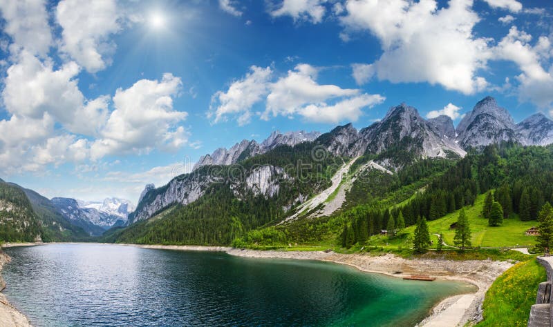 Alpine summer lake sunshiny panorama.