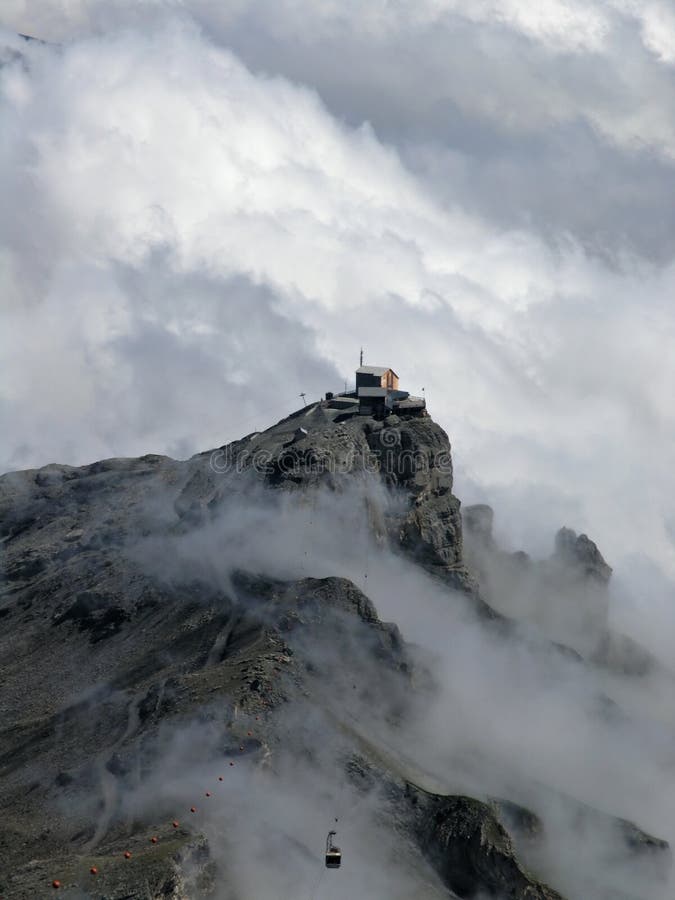 Alps with mist and cable car