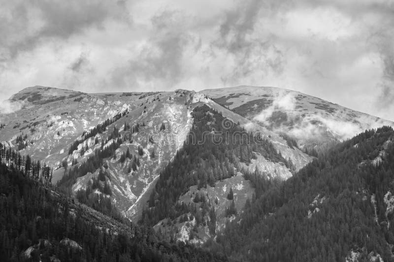 Alps mountains in clouds, black and white