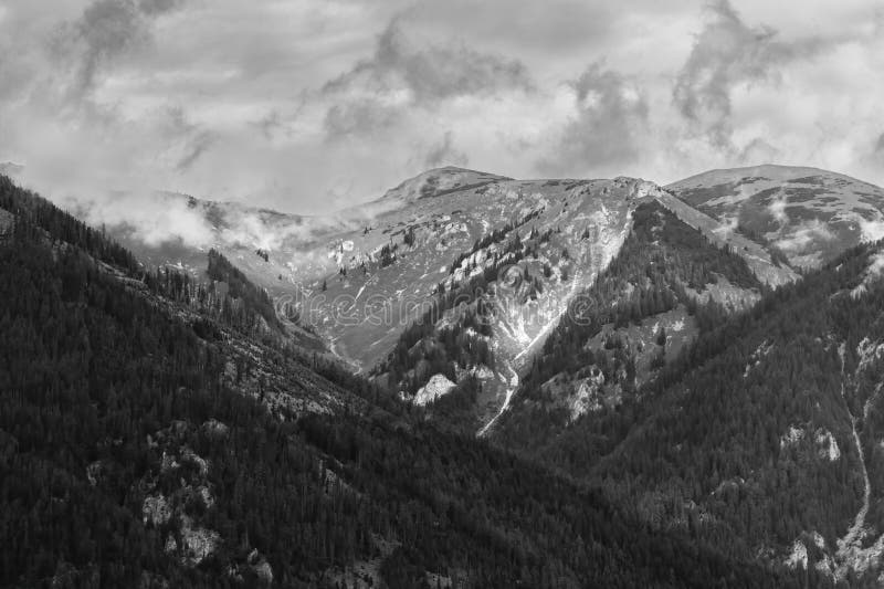 Alps mountains in clouds, black and white