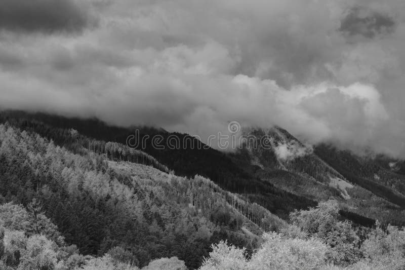 Alps mountains in clouds, black and white