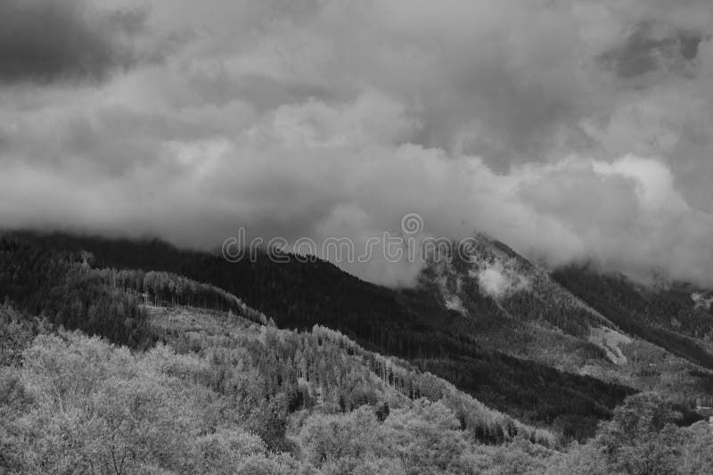 Alps mountains in clouds, black and white