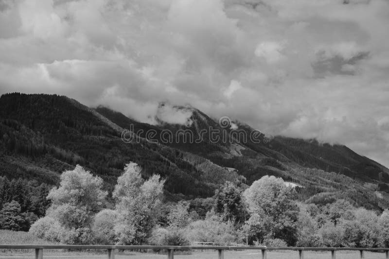 Alps mountains in clouds, black and white