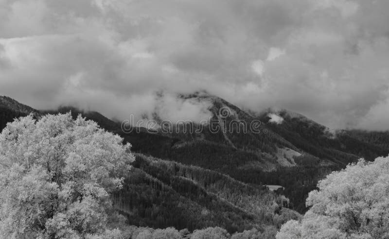 Alps mountains in clouds, black and white