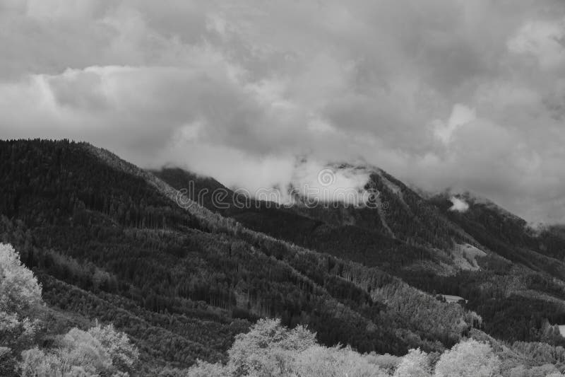 Alps mountains in clouds, black and white