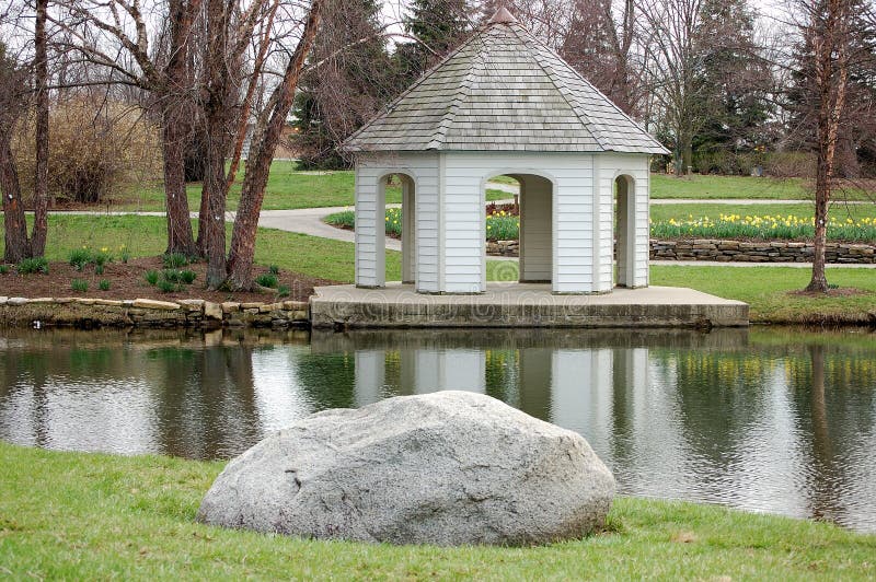 This is a gazebo and a rock by the lake. This is a gazebo and a rock by the lake.