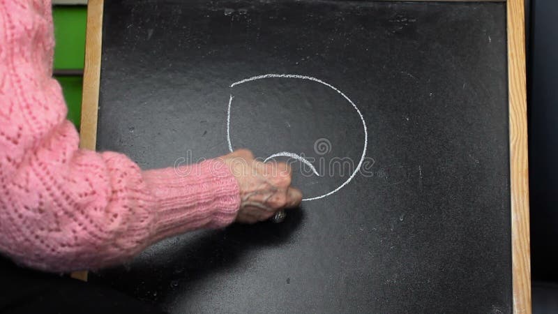 Alte Frau, die unglücklichen smiley auf Tafel zeichnet