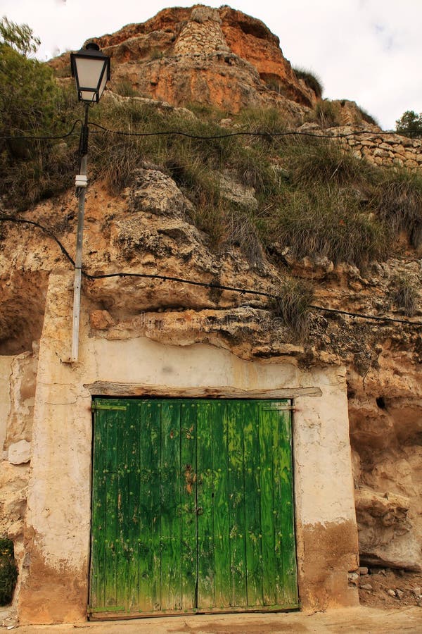 Alte Garage mit der grünen Holztür ausgegraben im Berg lizenzfreies stockfoto Alte Garage mit der grünen Holztür ausgegraben im Berg lizenzfreies stockfoto