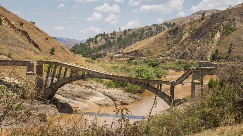 Old broken bridge over a muddy river on a landscape in Madagascar, Africa. Old broken bridge over a muddy river on a landscape in Madagascar, Africa.