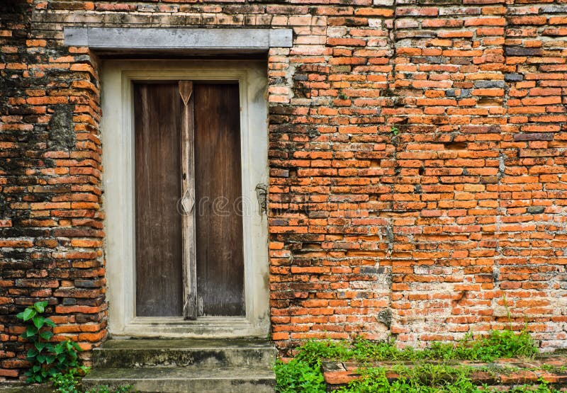 Thai wooden door on brick wall. Thai wooden door on brick wall