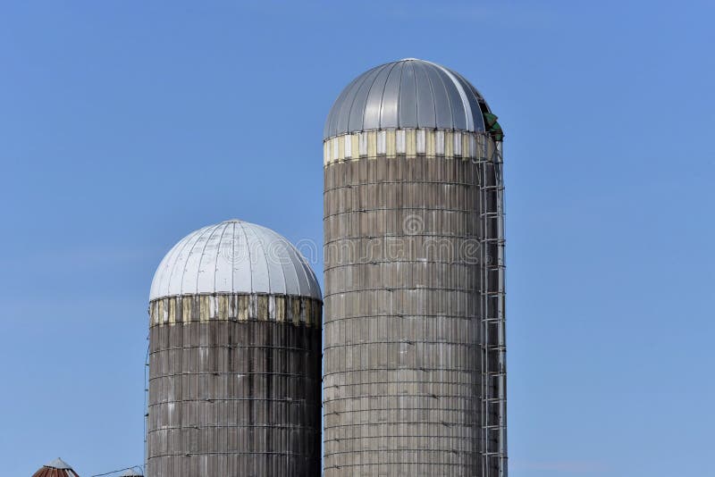 2 old silos in southern Wisconsin one painted cap and one unpainted cap. 2 old silos in southern Wisconsin one painted cap and one unpainted cap
