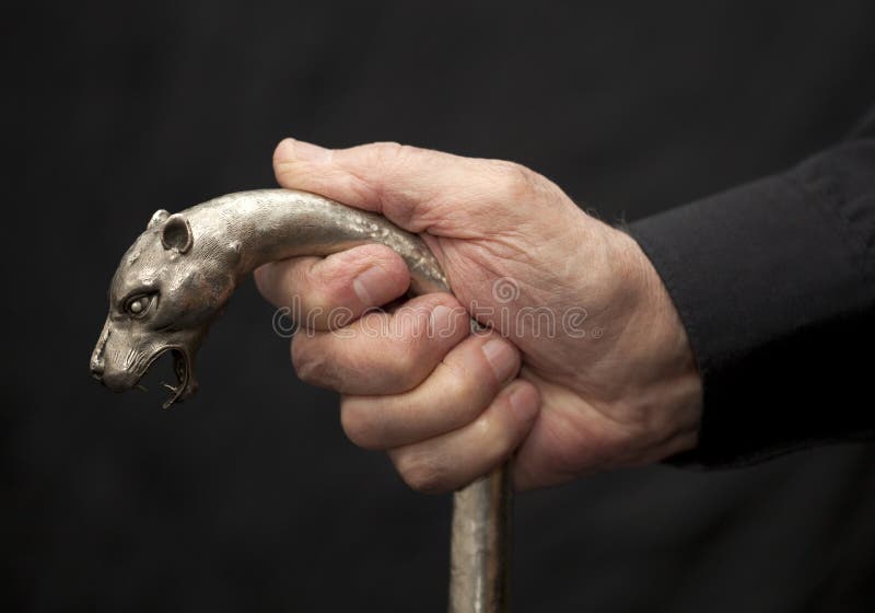 Old man with metal walking stick on black background. Old man with metal walking stick on black background