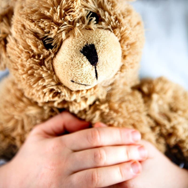 Alter Teddybär in den Händen eines Kindes lizenzfreie stockfotos Alter Teddybär in den Händen eines Kindes lizenzfreie stockfotos