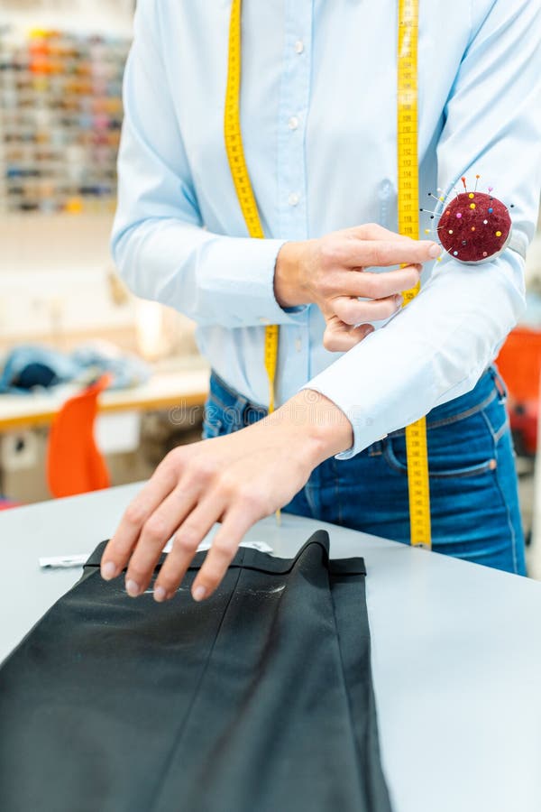 Alterations Tailor Working on Some Trousers Stock Photo Image of