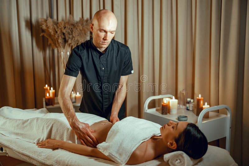 Alternative Medicine Spa Salon Therapist Doing Massage To Woman Lying