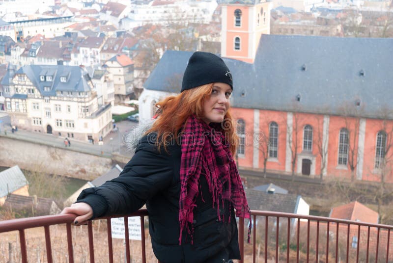 Young alternative punk emo girl looking at camera while standing on a observation point with bad kreuznach, germany in the background, horizontal. Young alternative punk emo girl looking at camera while standing on a observation point with bad kreuznach, germany in the background, horizontal